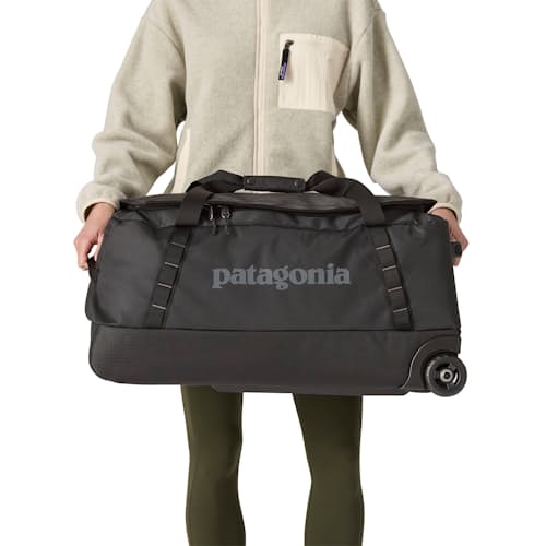 on model image of Black Hole Wheeled Duffel Bag - 70L