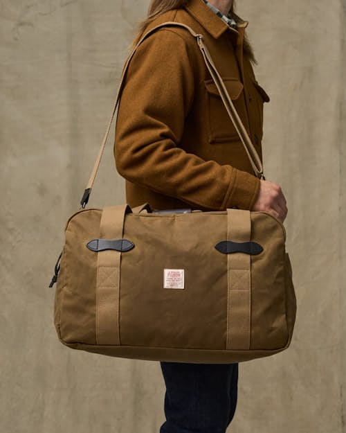 on model image of TIn Cloth Medium Duffle Bag