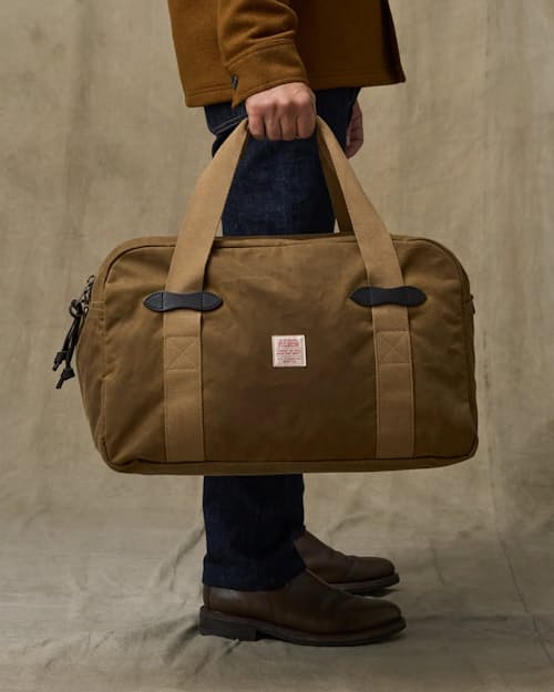 on model image of TIn Cloth Medium Duffle Bag