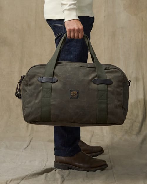 on model image of TIn Cloth Medium Duffle Bag