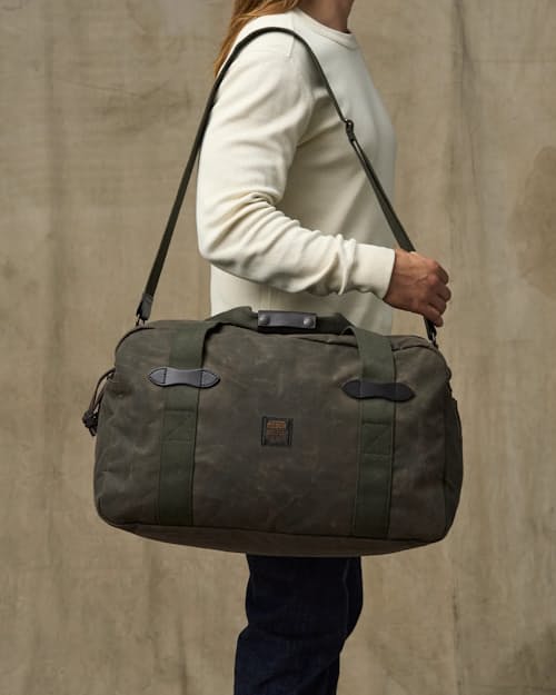 on model image of TIn Cloth Medium Duffle Bag