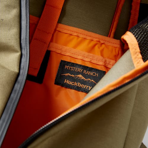 laydown image of Huckberry x Mystery Ranch Urban Assault 21L