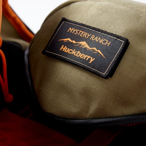 laydown image of Huckberry x Mystery Ranch Urban Assault 21L