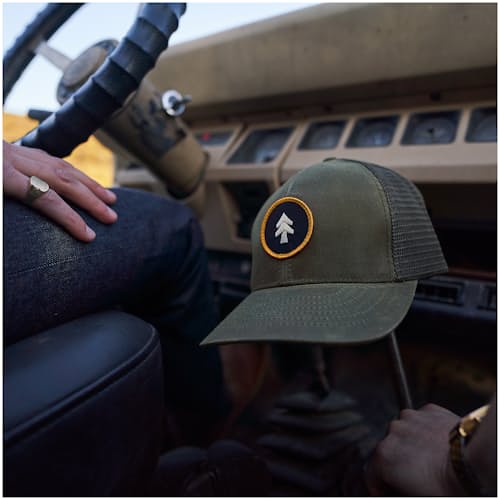 lifestyle image of Waxed Canvas Tree Trucker Hat - Medium Profile