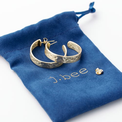 laydown detail image of Women's Hammered Gold Hoop Earrings