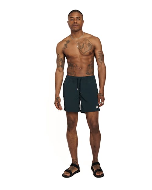 on model image of Classic Solid Swim Short - 5.5"