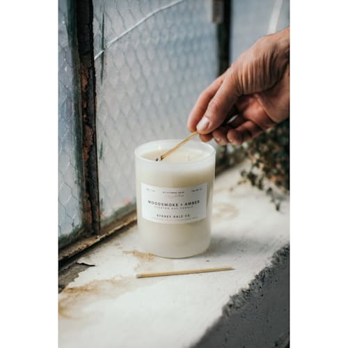 laydown image of Woodsmoke + Amber Candle
