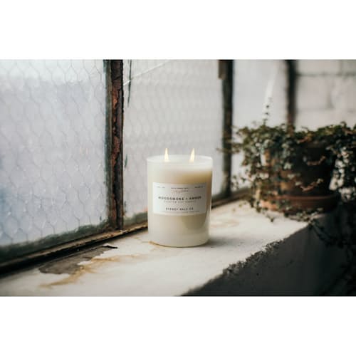 laydown image of Woodsmoke + Amber Candle