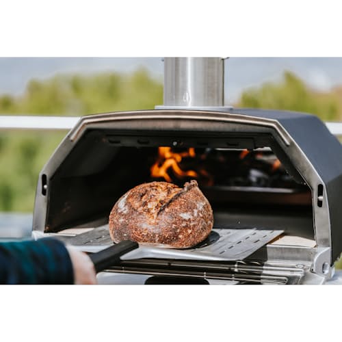 lifestyle image of Ooni Karu 16 Wood and Charcoal-Fired Portable Pizza Oven