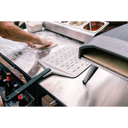 lifestyle image of 14" Perforated Pizza Peel