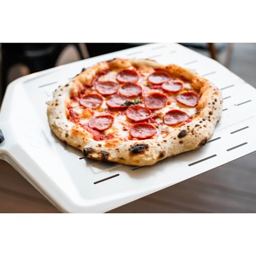 lifestyle image of 14" Perforated Pizza Peel