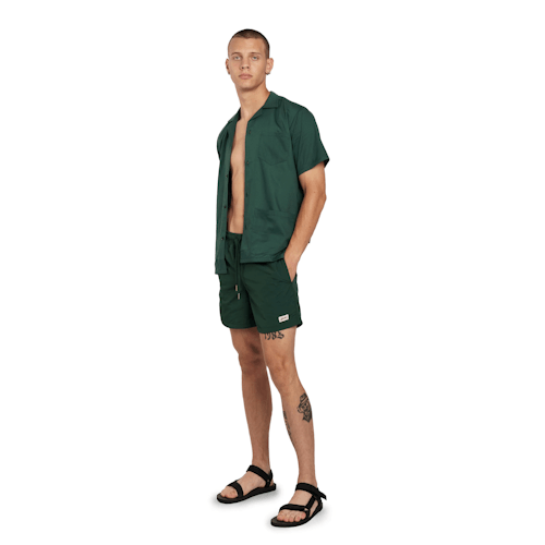 on model image of Classic Solid Swim Short - 5.5"