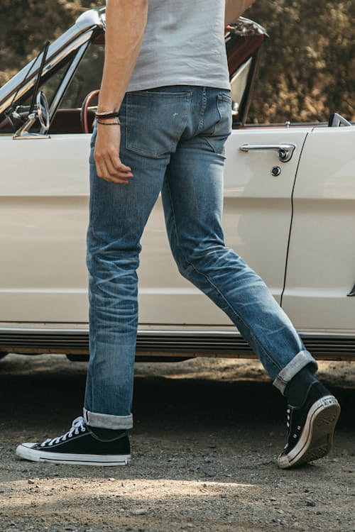 lifestyle image of The Pen Slim Straight Stretch Selvedge Denim Jeans