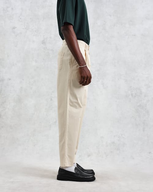 on model image of Raleigh Pleated Tapered Pant
