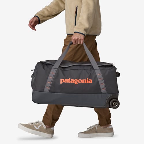 on model image of Black Hole Wheeled Duffel - 70L