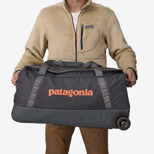 on model image of Black Hole Wheeled Duffel - 70L