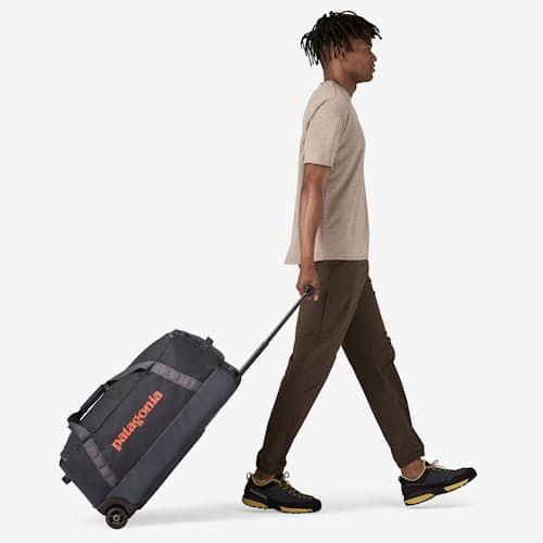 on model image of Black Hole Wheeled Duffel - 70L