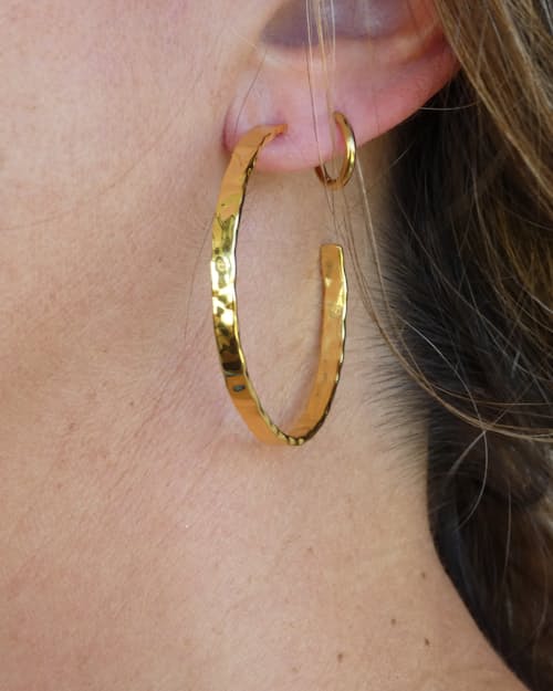 lifestyle image of Women's Thin Hammered Gold Hoop Earrings