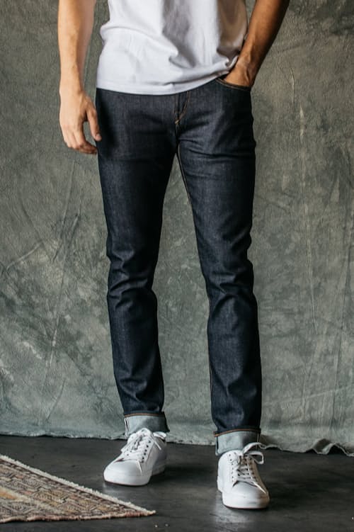 lifestyle image of The Scissors Slim Tapered Stretch Selvedge Denim Jeans