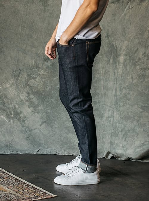 lifestyle image of The Scissors Slim Tapered Stretch Selvedge Denim Jeans