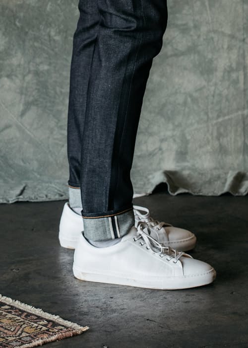 lifestyle image of The Scissors Slim Tapered Stretch Selvedge Denim Jeans