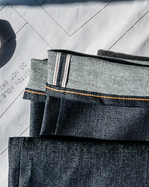 lifestyle image of The Scissors Slim Tapered Stretch Selvedge Denim Jeans