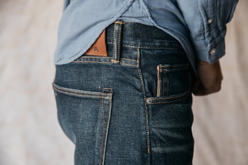 on model image of The Scissors Slim Tapered Stretch Selvedge Denim Jeans