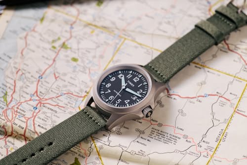 laydown detail image of Huckberry x Timex Titanium Automatic Field Watch