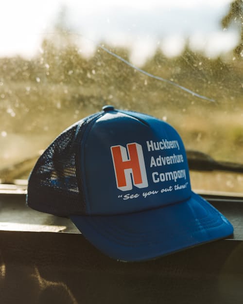 lifestyle image of Huckberry Adventure Company Foam Trucker Hat