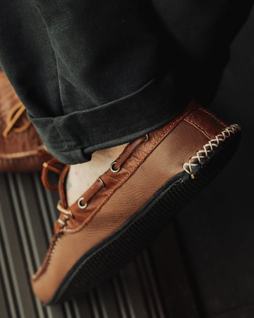 lifestyle image of Huckberry x Quoddy Coolslide Stamped Leather Slipper