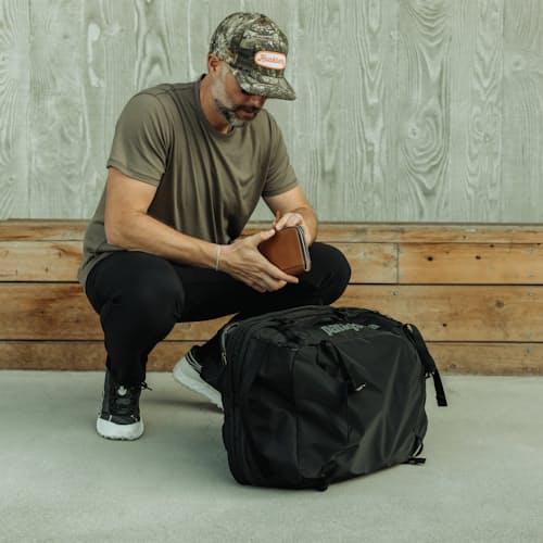 lifestyle image of Black Hole MLC Travel Backpack - 45L