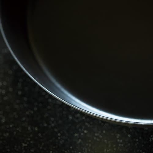 lifestyle image of Cast Iron Deep Frying Pan with Lid - 9.4"