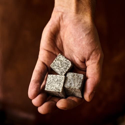 laydown image of Dark Granulite Hornblende Whiskey Stones with Tray