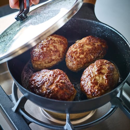 lifestyle image of Cast Iron Deep Frying Pan with Lid - 9.4"